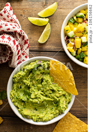 Tortilla chips with dips, guacamole and salsa Tortilla chips with dips, guacamole and salsa 106156662