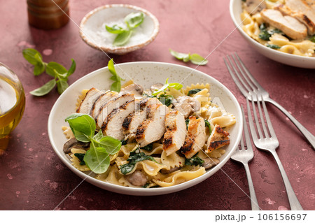 Grilled chicken with mushroom and spinach pasta Grilled chicken with mushroom and spinach pasta 106156697