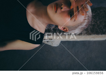 屋内で寝そべる女性 106159856