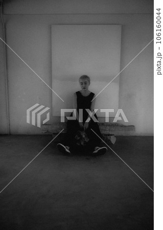 屋内に佇む若い女性のモノクロ写真 屋内に佇む若い女性のモノクロ写真 106160044