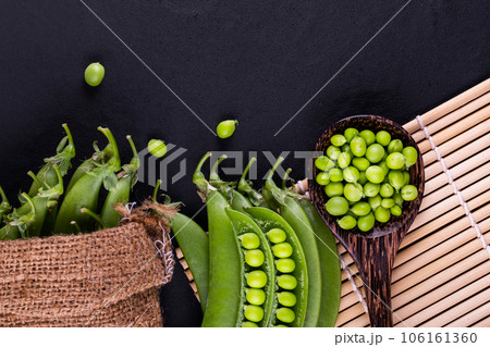 Sugar snap peas with mint on a rustic wood background 106161360