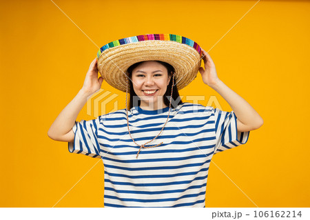 Beautiful Asian girl wearing a Mexican hat 106162214