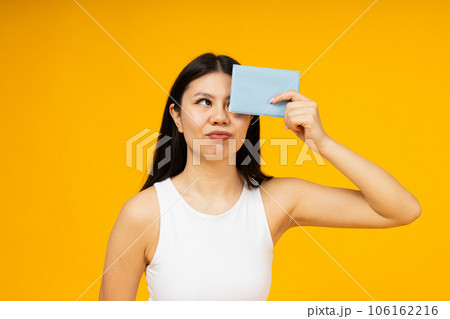 A girl of Asian appearance with a passport in her hands. 106162216