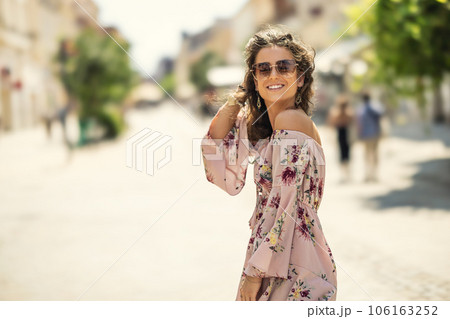 Happy young smiling woman in summer outfit with sunglasses. Outdoor portrait 106163252