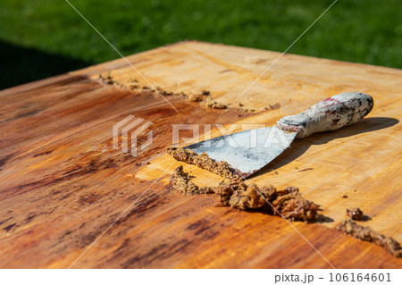 Removing the old paint with a trowel, renovation works Removing the old paint with a trowel, renovation works 106164601