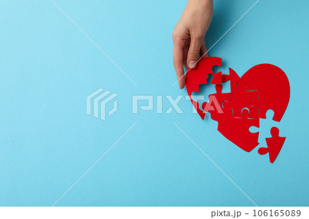 Red heart from puzzles on a blue background. Blood donation, place for text Red heart from puzzles on a blue background. Blood donation, place for text 106165089