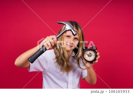 Kid girl holding hammer and alarm clock smiling with a happy and cool smile on face. showing teeth. 106165933