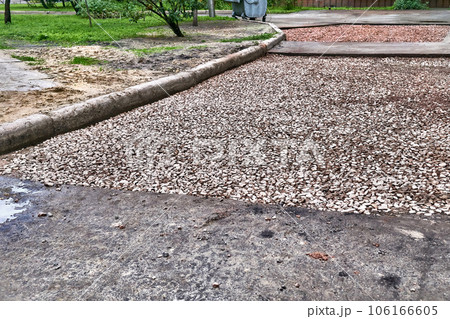 Road repair. Roadbed with laid gravel before asphalt laying 106166605