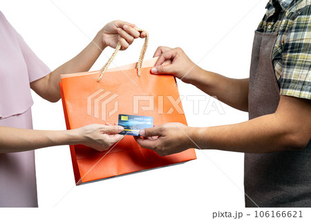 Asian Consumer Making a Purchase with Credit Card and grap Shopping Bag from sale staff Asian Consumer Making a Purchase with Credit Card and grap Shopping Bag from sale staff 106166621