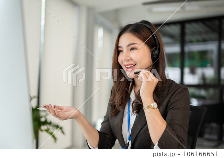 An attractive Asian female call centre operator is looking at her computer screen An attractive Asian female call centre operator is looking at her computer screen 106166651