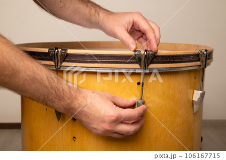 close-up of repairing and adjusting the tension of a kick bass drum 106167715