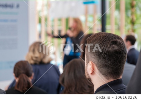 Unrecognizable male in crowd of anonymous people taking part in conference and listening to presentation of speaker 106168226