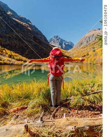 Hiker tourist happy and enjoying near lake in autumnal mountains. Hiker tourist happy and enjoying near lake in autumnal mountains. 106168478