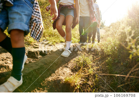 Cropped image of kids legs walking on path in forest, going hiking on warm sunny day Cropped image of kids legs walking on path in forest, going hiking on warm sunny day 106169708