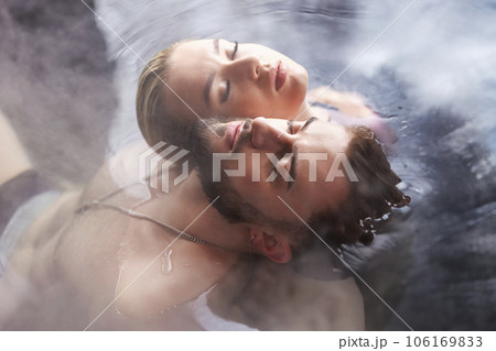 young couple sitting in a tub filled with water young couple sitting in a tub filled with water 106169833