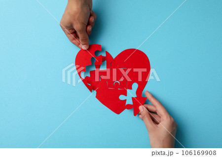Red heart from puzzles on a blue background. Blood donation 106169908