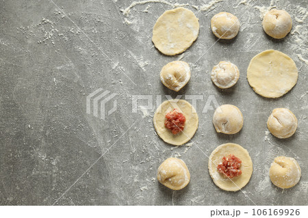 Cooking home food concept with raw dumplings Cooking home food concept with raw dumplings 106169926