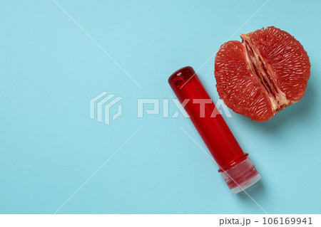 Lubricant with half a grapefruit on a blue background, place for text Lubricant with half a grapefruit on a blue background, place for text 106169941
