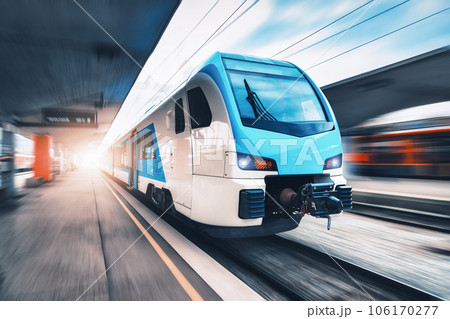 High speed train in motion on the railway station at sunset High speed train in motion on the railway station at sunset 106170277