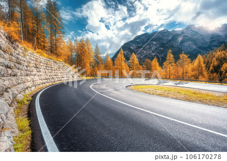 Road in mountains at sunny day in golden autumn. Dolomites, Italy Road in mountains at sunny day in golden autumn. Dolomites, Italy 106170278