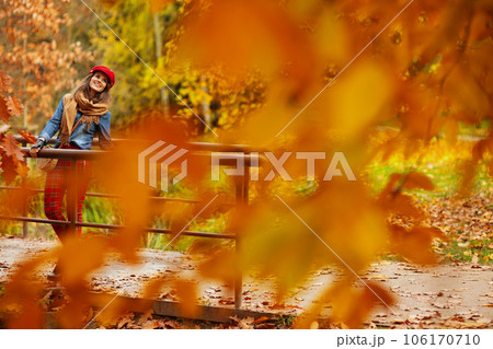 smiling elegant 40 years old woman in jeans shirt and red hat smiling elegant 40 years old woman in jeans shirt and red hat 106170710