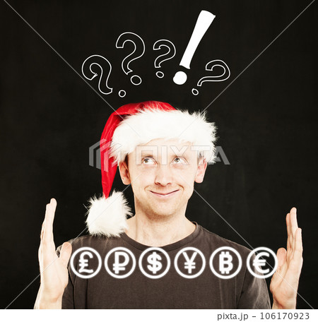 Man in Santa Hat with currency icons in his Hands. Sale Concept 106170923