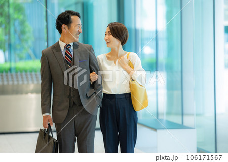 ミドルカップルを案内する受付の女性 106171567