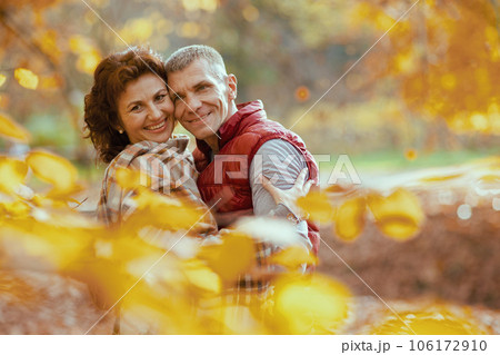 Portrait of smiling modern couple in park embracing Portrait of smiling modern couple in park embracing 106172910