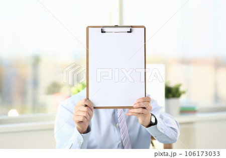 Businessman holds clipboard with paper Businessman holds clipboard with paper 106173033