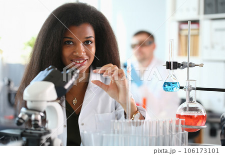 A male chemist holds test tube of glass 106173101