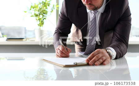 Male arm in suit and tie fill form clipped to pad Male arm in suit and tie fill form clipped to pad 106173538