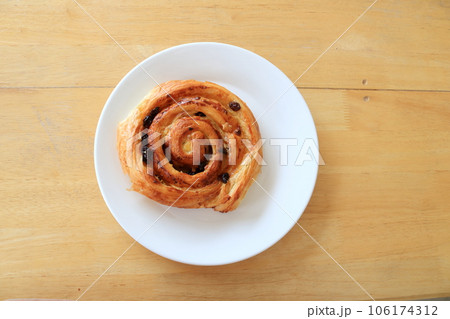 Raisin bread in white dish on wood table. Raisin bread in white dish on wood table. 106174312
