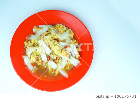 Sauted white mustard greens with scrambled eggs served on a white plate 106175731