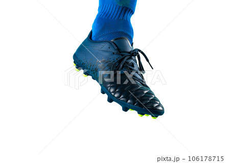 Isolated football  player plays with soccerball in a match 106178715