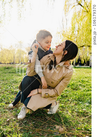 Single mother spending some time at the park with her little son Single mother spending some time at the park with her little son 106179370