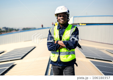 Engineers with safety helmet checking solar system at solar power farm 106180357
