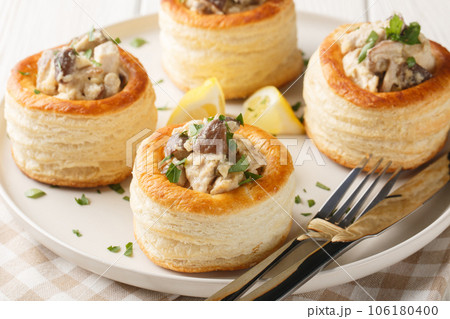 Delicious classic vol-au-vent stuffed with chicken, mushrooms in a creamy sauce close-up in a plate. horizontal 106180400
