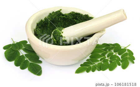 Moringa leaves with mortar and pestle 106181518