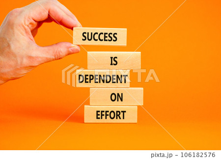 Success and effort symbol. Concept words Success is dependent on effort on wooden block. Beautiful orange table orange background. Businessman hand. Business success and effort concept. Copy space. 106182576