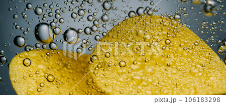 Deep fried potato chips under golden oil water. Frying rounded potatoes chip with hot boiling oil bubbles. Fast food and snack. Underwater cooking oily french fries or potatos chips in oils background 106183298