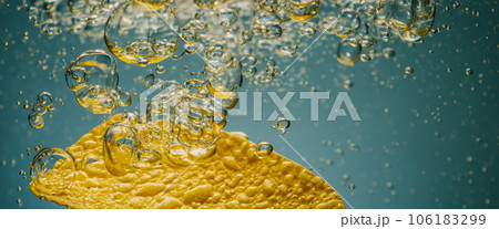 Deep fried potato chips under golden oil water. Frying rounded potatoes chip with hot boiling oil bubbles. Fast food and snack. Underwater cooking oily french fries or potatos chips in oils background 106183299