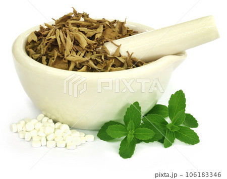 Dry and green stevia with pills Dry and green stevia with pills 106183346
