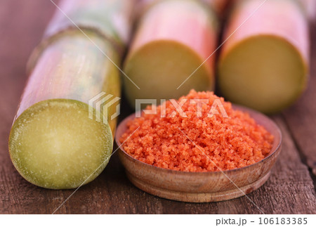 Piece of sugarcane with red sugar Piece of sugarcane with red sugar 106183385