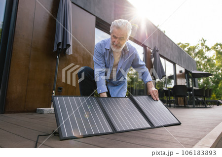 Caucasian man with solar panel innovation technology alternative energy. 106183893