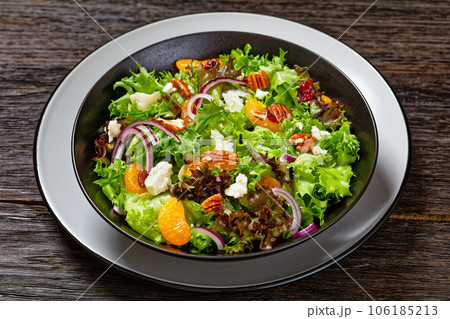 Mandarin Orange Salad in black bowl, top view 106185213