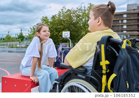 Friendship communication of children of boy in wheelchair and girl Friendship communication of children of boy in wheelchair and girl 106185352