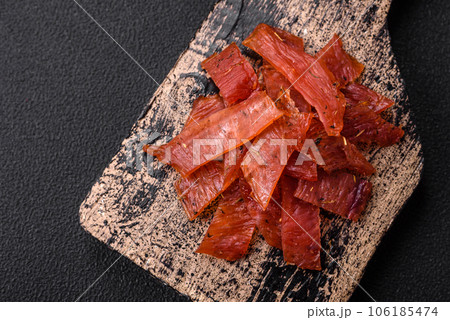 Delicious dried veal or turkey jerky with salt, spices and herbs 106185474