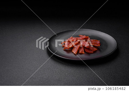 Delicious dried veal or turkey jerky with salt, spices and herbs 106185482