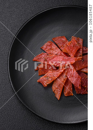 Delicious dried veal or turkey jerky with salt, spices and herbs Delicious dried veal or turkey jerky with salt, spices and herbs 106185487