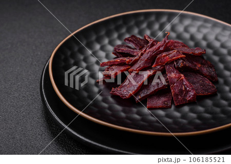 Delicious dried veal or turkey jerky with salt, spices and herbs Delicious dried veal or turkey jerky with salt, spices and herbs 106185521